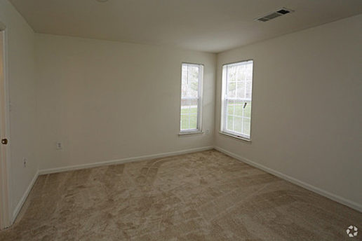 Carpeted bedroom with two windows
